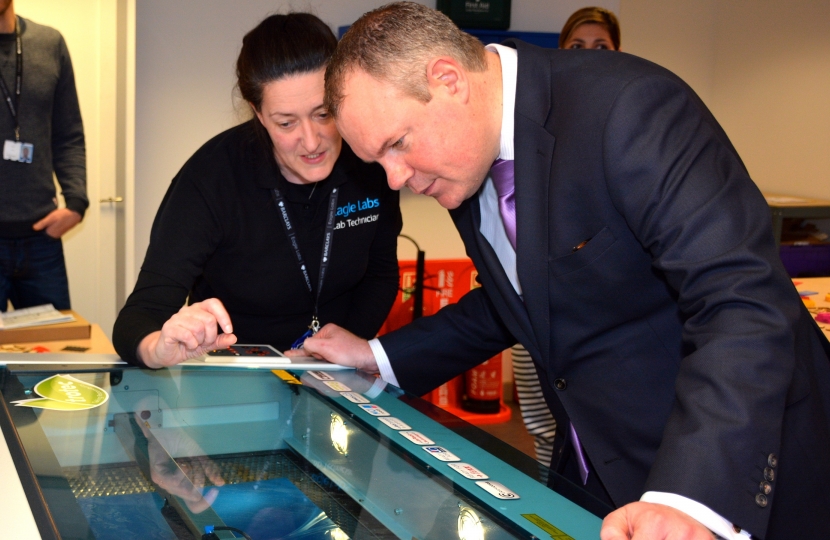 Conor Burns MP using the Eagle Lab’s laser cutter.