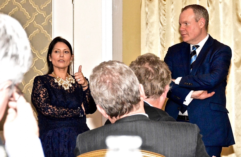 Conor and Priti Patel addressing the 66 Club dinner in Bournemouth.