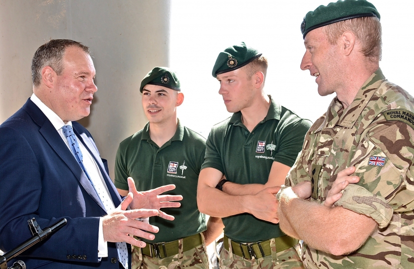 Conor pictured talking with three marines on Bournemouth beach.