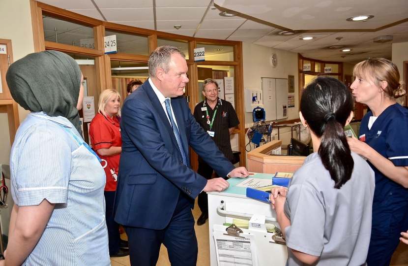 Conor pictured speaking with several nurses at Poole Hospital.