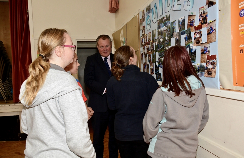Conor pictured being shown pictures of former activities by the Girl Guides. 