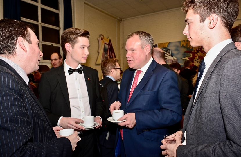 Conor pictured speaking to a teacher and some students at the refreshments after the ceremony.