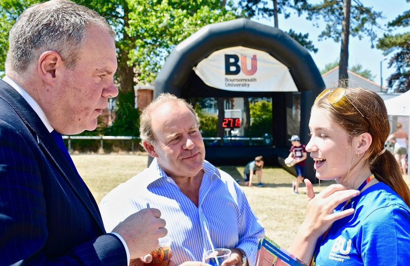Conor speaking with a Bournemouth University representative and Winton East Councillor Don McQueen at the Winton carnival.