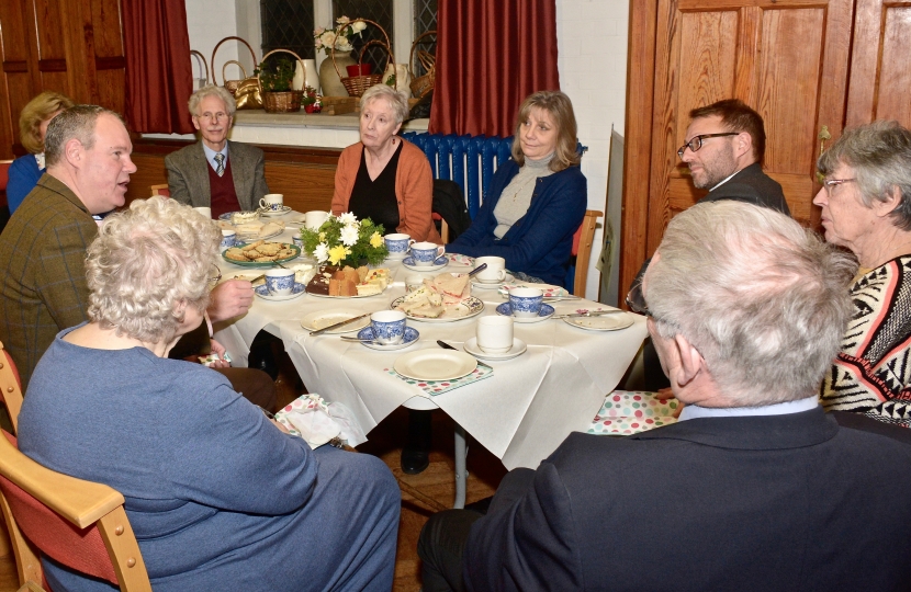 Conor enjoys a traditional afternoon tea with the Revd Michael Smith and members of the Parish Church Council.