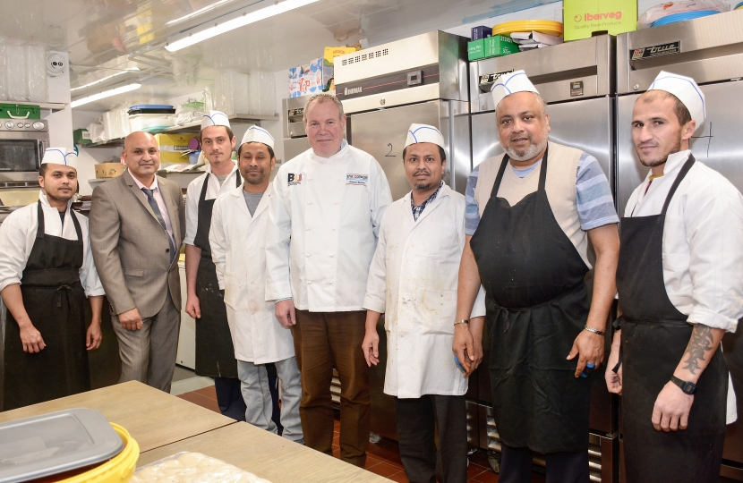 Conor with the staff in the Spice of India kitchen.
