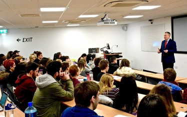 Conor delivering his lecture on tourism at Bournemouth University.