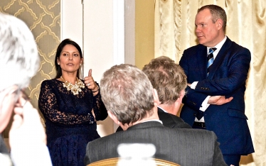 Conor and Priti Patel addressing the 66 Club dinner in Bournemouth.