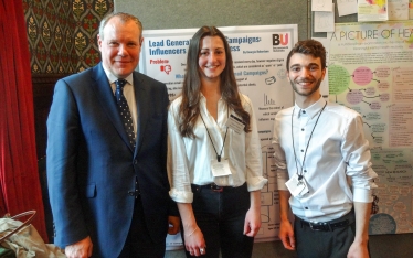 Conor with BU Students Georgia and Jordan, presenting their research at the Posters in Parliament event.