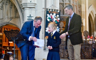 Conor and Mark Saxby, Head Teacher of St Luke’s pictured presenting Charlotte Crowe with her prize.