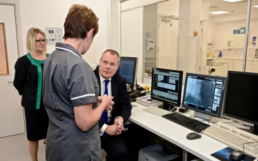 Conor pictured being shown new facilities within the hospital.
