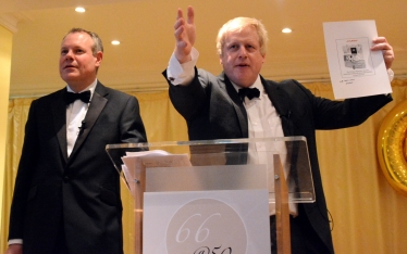 Boris Johnson acts as auctioneer, alongside Sixty-Six Club President Conor Burns